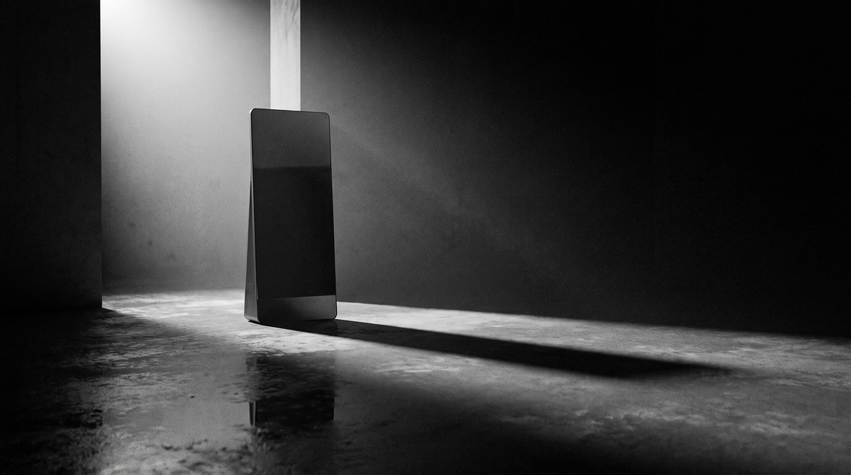 Cinematic black-and-white photograph of a dark, powered-off home-gym smart mirror standing alone in a minimal room